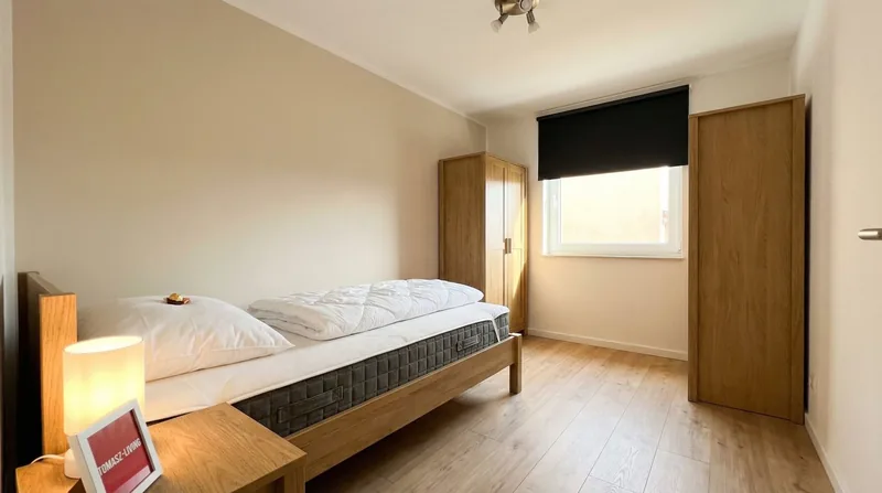 Zimmer mit breitem Holzbett und Kleiderschrank
